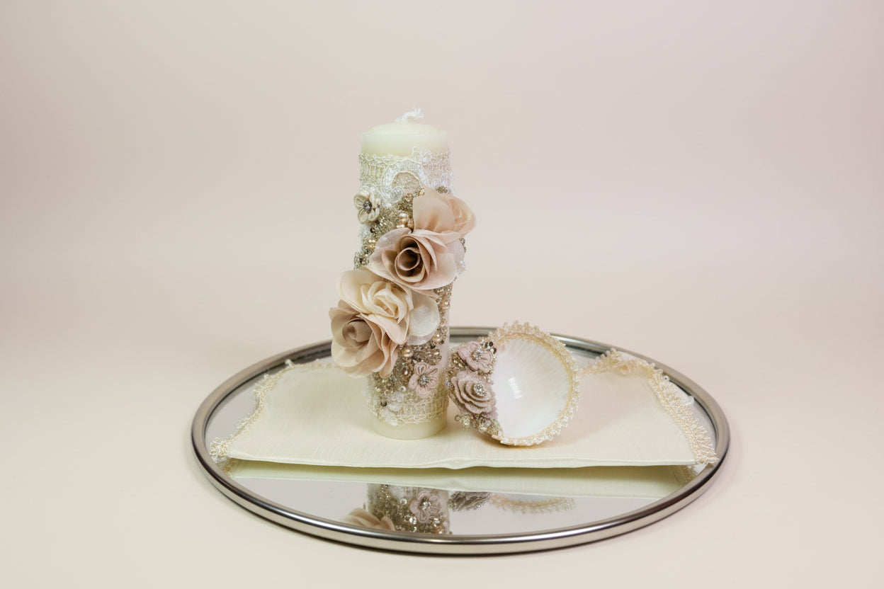 Decorative candle with floral elements on a white background