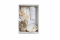 A 3 piece girl baptism candle set in ivory, including a decorated candle, shell, and hankershief, displayed in an open box with floral patterns.
