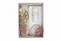 A 3 piece girl baptism candle set in champagne style, including a decorated candle with a floral pattern, a natural shell, and a hankerchief.